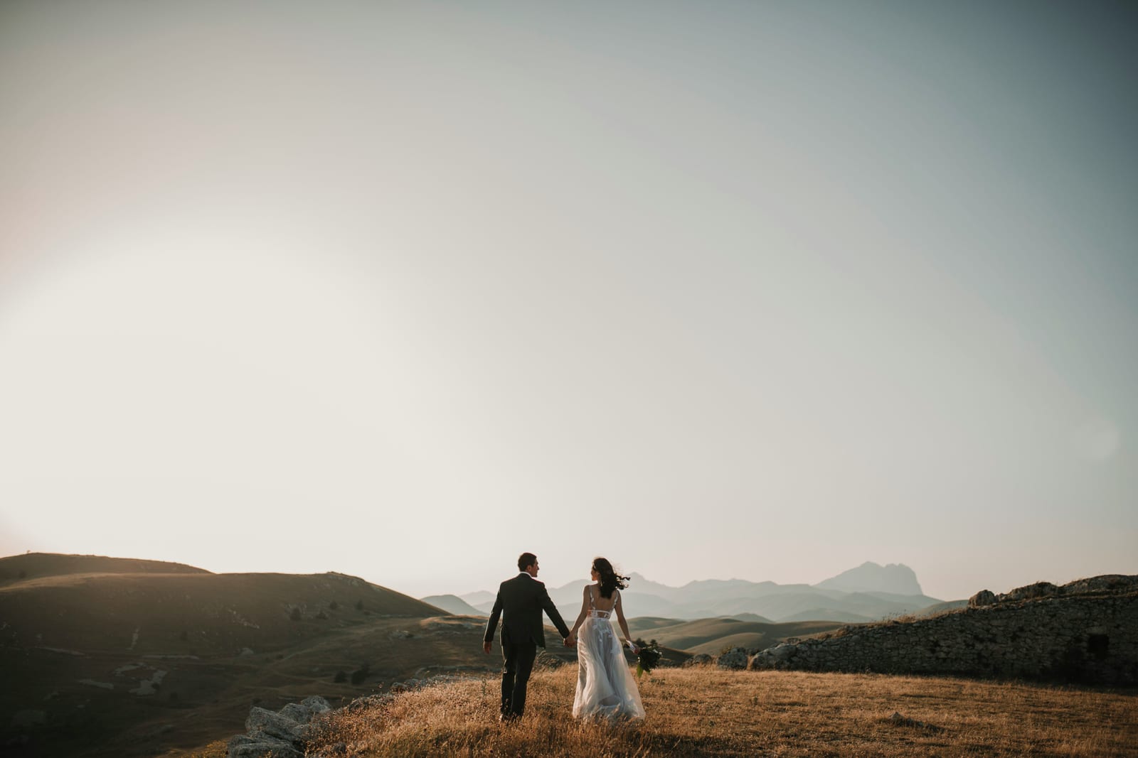 Couple in a mountain landscape at sunset