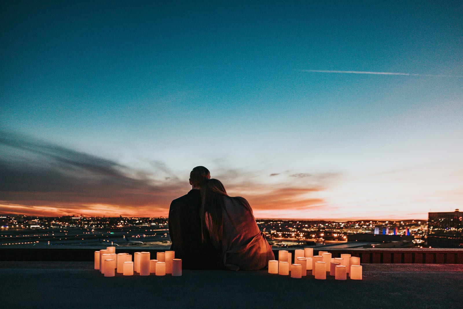 Couple by candlelight over the city skyline