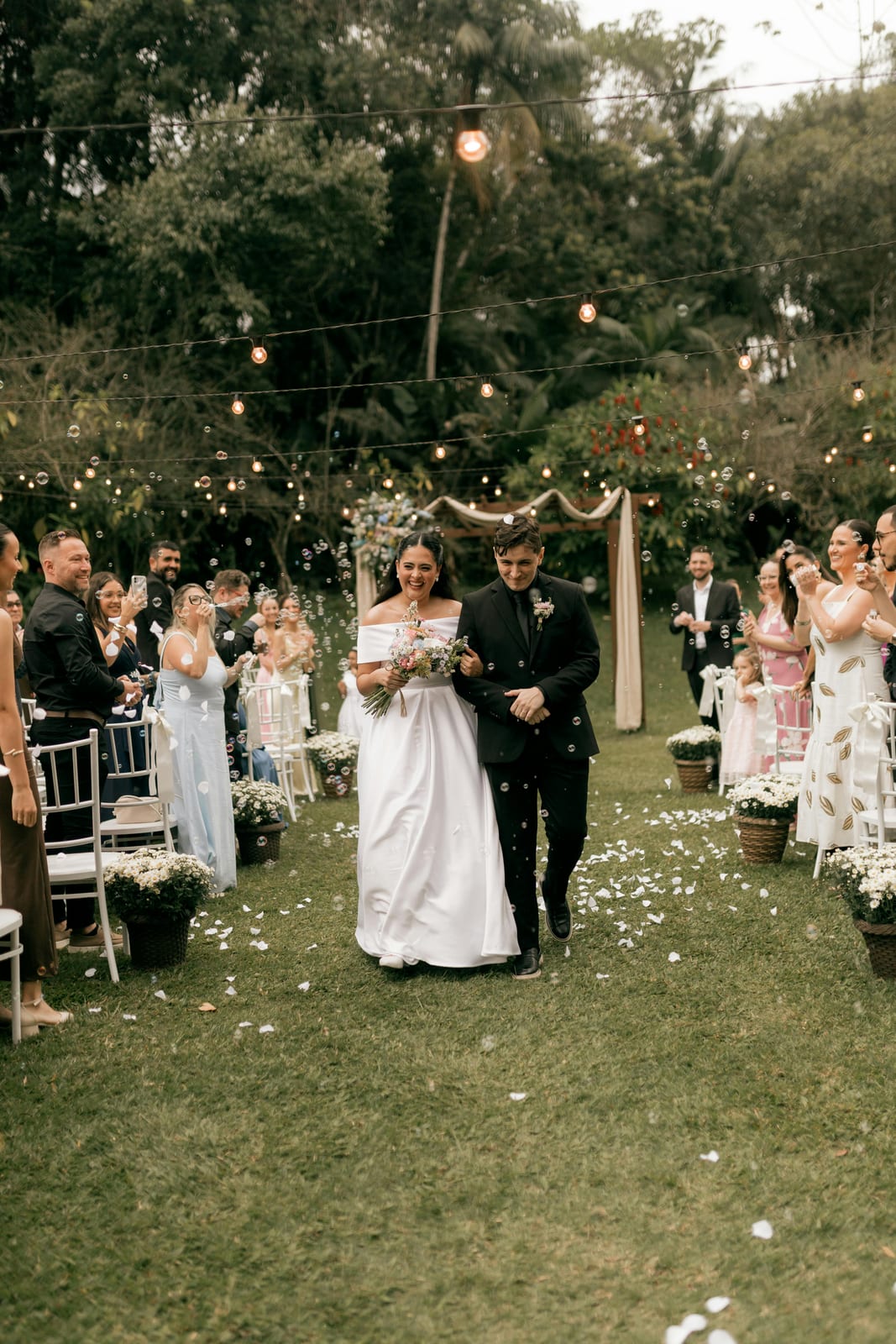 Couple in a confetti shower after the ceremony